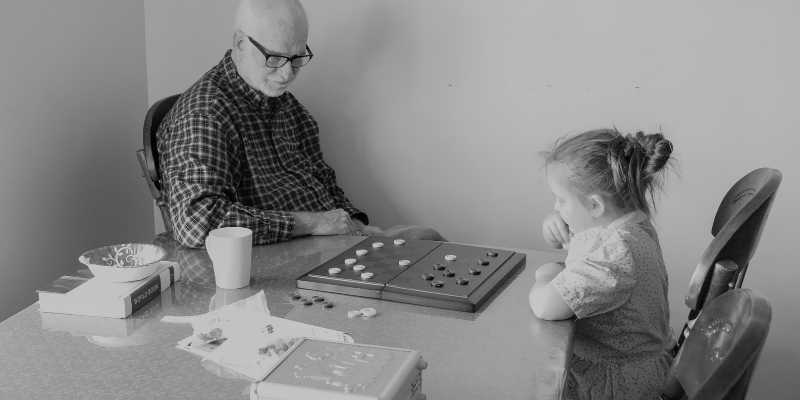 A small child playing checkers